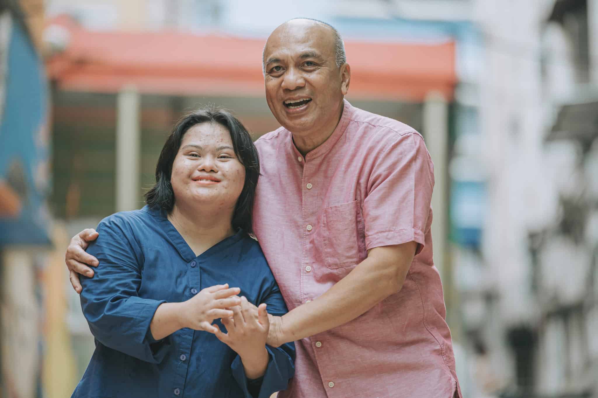 happy asian malay autism down syndrome female  bonding  with her father in city street