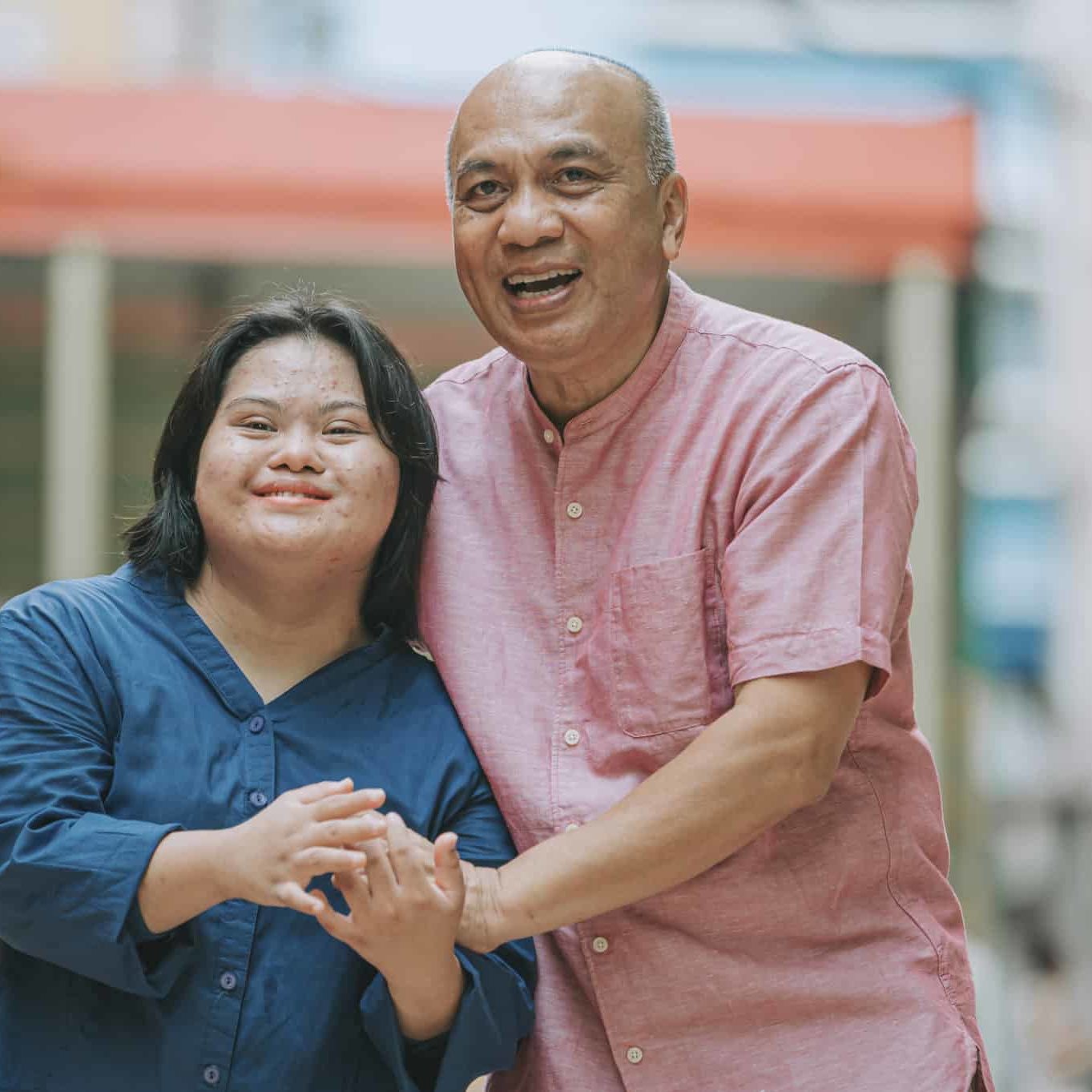 happy asian malay autism down syndrome female  bonding  with her father in city street